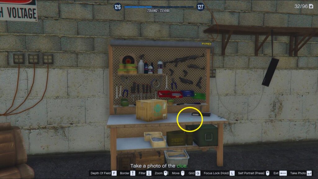 A workshop containing tools, adhesives, and weapons alongside a keycard highlighted by a thin, yellow circle.