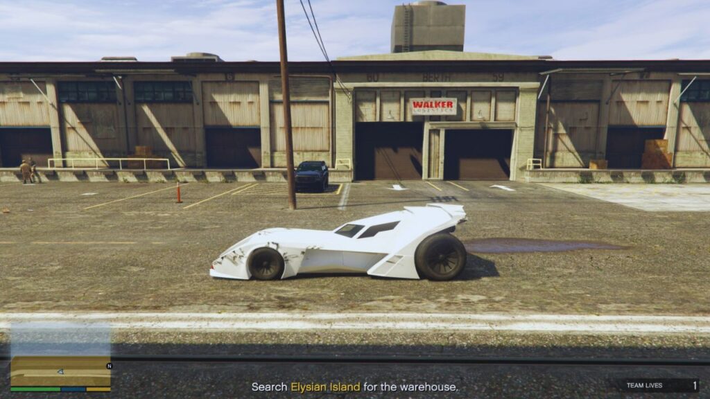 The GTA Online Protagonist driving a Vigilante in front of several warehouses in Elysian Island.